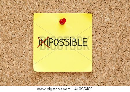 Picture or Photo of The word Impossible turning into Possible on yellow sticky note.