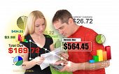 image of money  - A young man and woman couple are looking at bills and calculating payments and interest charges - JPG 