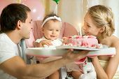 foto of  photo  - one-year-old little girl with daddy and mammy solemnize birthday happy laughter horizontal photo
** Note: Shallow depth of field - JPG 
