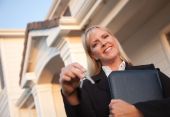 image of agent  - Female Real Estate Agent Handing Over Keys in Front of Beautiful House - JPG 