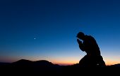 picture of religion  - Man praying on the summit of a mountain at sun set with the moon in the sky.
** Note: Slight blurriness, best at smaller sizes - JPG 