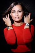 image of watch  - The beautiful girl with a wrist watch against a dark background - JPG 