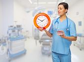 picture of medical doctors  - Doctor with pills and clock at medical office - JPG 