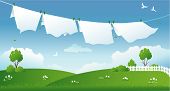pic of blue sky  - Illustration of drying laundry at a green field - JPG 
