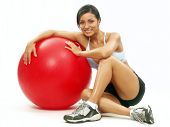 stock photo of fitness  - Young Woman doing fitness exercise with a red ball - JPG 