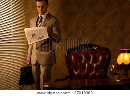 Picture or Photo of Retro businessman reading newspaper