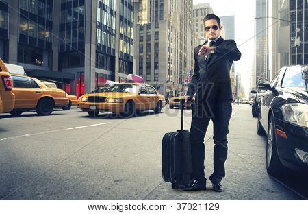 Picture or Photo of Businessman looking at his watch in New York