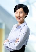 stock photo of leadership  - Portrait of a handsome successful business woman wearing white shirt and black skirt at business centre - JPG 
