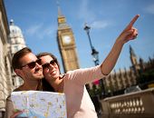 foto of map  - Happy summer tourists in London holding a map - JPG 