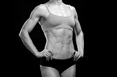 pic of fitness  - Black and white portrait of a female fitness bodybuilder posing against black background - JPG 