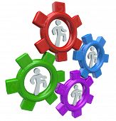 stock photo of teamwork  - Four people run in colorful gear wheels to symbolize collaboration and teamwork in working together toward a common goal - JPG 