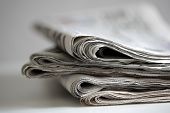 stock photo of newspaper  - Newspapers folded and stacked concept for global communications - JPG 