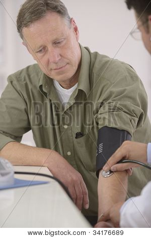 Picture or Photo of Doctor checking blood pressure of his patient