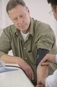 picture of pressure  - Doctor checking blood pressure of his patient - JPG 