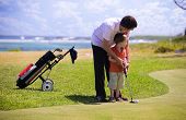 pic of golf  - Father teaching his son how to play golf - JPG 