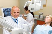 stock photo of medical doctors  - Friendly dentist with female patient regular visit at dental surgery - JPG 