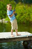 pic of youngster  - Photo of little kid pulling rod while fishing on weekend - JPG 