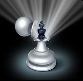 stock photo of leadership  - Power within and Leadership potential as an emerging business as a chess game king figurine revealed inside a large pawn disguise as a concept for strategy of success with a star burst shinning light on black - JPG 