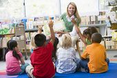 stock photo of kindergarten  - Students in class volunteering for teacher - JPG 