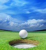 foto of golf  - golf ball on lip of cup of lovely beautiful golf course - JPG 