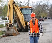 picture of construction worker  - road construction worker walks determinately toward the camera - JPG 