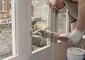 stock photo of home  - Painter painting a door white inside a home
 - JPG 