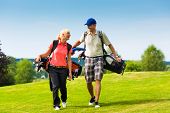 image of golf  - Young sportive couple playing golf on a golf course - JPG 