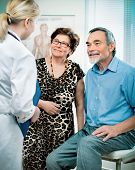 image of medical doctors  - senior couple visiting a doctor at the doctor - JPG 