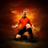 stock photo of competition  - Football player in fires flame on the outdoors field - JPG 