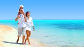 stock photo of beach  - View of happy young family having fun on the beach - JPG 