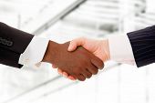 stock photo of business people  - Business team shaking hands while in their office - JPG 