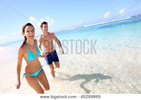 Picture or Photo of Couple running on a sandy beach