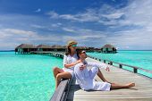 pic of beach  - Couple on a tropical beach jetty at Maldives - JPG 