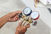 pic of pressure  - close up Technician inspection refrigerant pressure of airconditioner
 - JPG 
