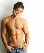 pic of fitness  - Sexy portrait of a young muscular male model with great happy smile against white wall - JPG 