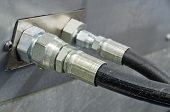 picture of pressure  - Two Hydraulic Pressure Hoses connecting into a Manifold Block for Testing - JPG 