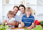 stock photo of family  - Happy Family Preparing Dinner Together In A Kitchen - JPG 