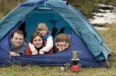 stock photo of family  - Happy family camping in tent - JPG 
