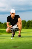 stock photo of golf  - Young golf player on course putting - JPG 