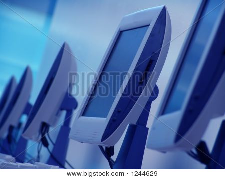 Picture or Photo of Some monitors at a computer class room