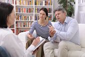 stock photo of meeting  - married couple consults talking to psychologist - JPG 