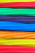 image of blue sky  - Background texture of horizontal strands of rainbow colored licorice sticks - JPG 