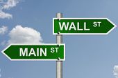 stock photo of wall street  - An American road sign with sky background and copy space for your message Wall Street and Main Street - JPG 