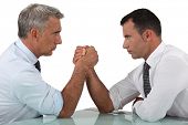 stock photo of leadership  - businessmen arm wrestling - JPG 