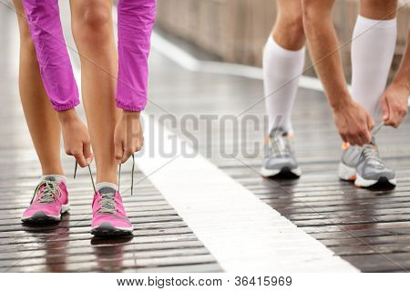 Picture or Photo of Runner feet. Running couple closeup of running shoes. Woman barefoot running shoes in foreground. Couple jogging on Brooklyn Bridge, New York.