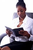 foto of africanamerican  - african american business woman reading book in chair - JPG 