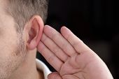 picture of quiet  - Man with hand on ear listening for quiet sound or paying attention - JPG 