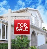 picture of home  - A home is advertising a for sale sign on a wooden sign post in red - JPG 