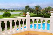 stock photo of golf  - Golf course view from house with pool white balustrade - JPG 