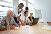 picture of meeting  - Business people in a meeting with a laptop computer - JPG 